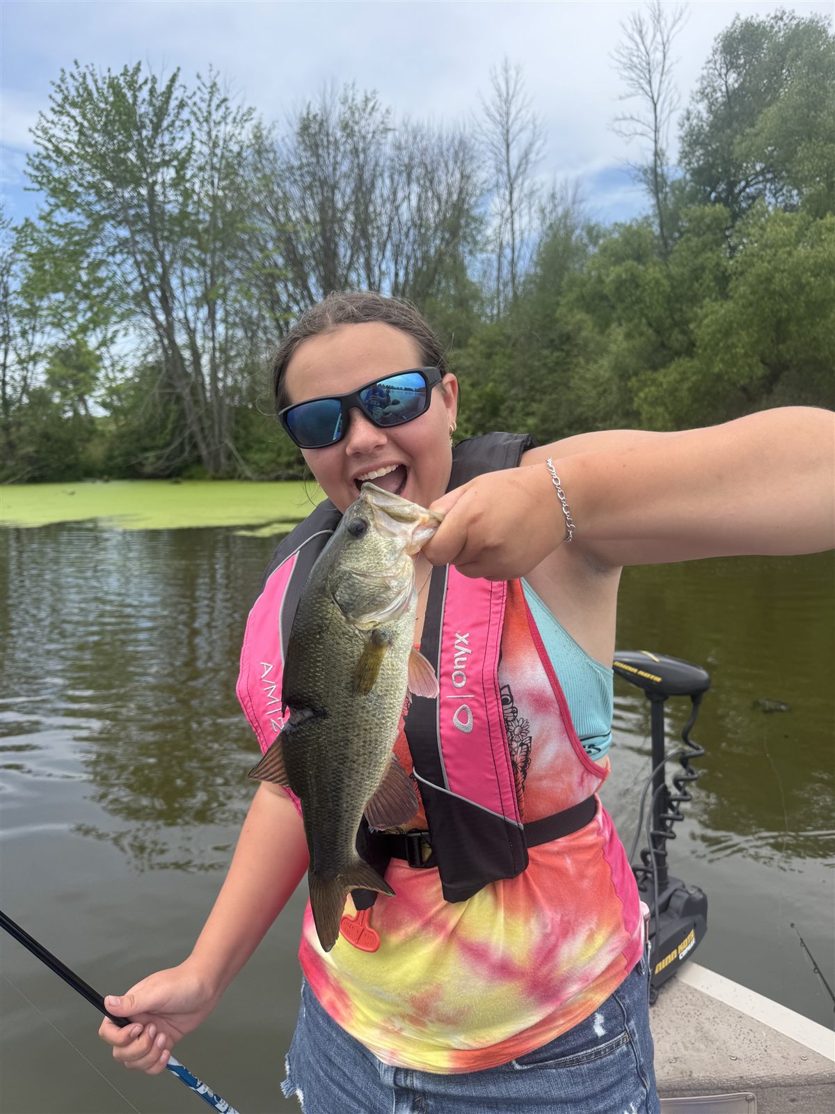 Young angler proudly holding a largemouth bass