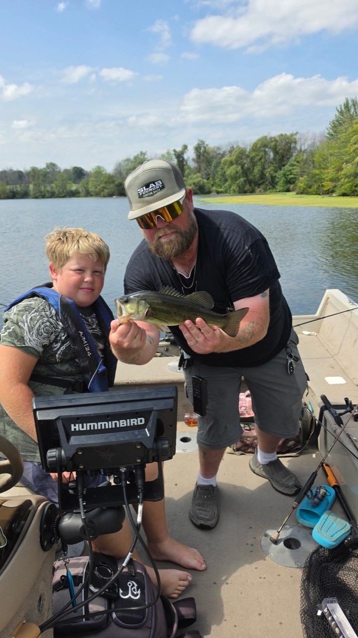 Slab Foundry angler and young fishing partner holding a bass