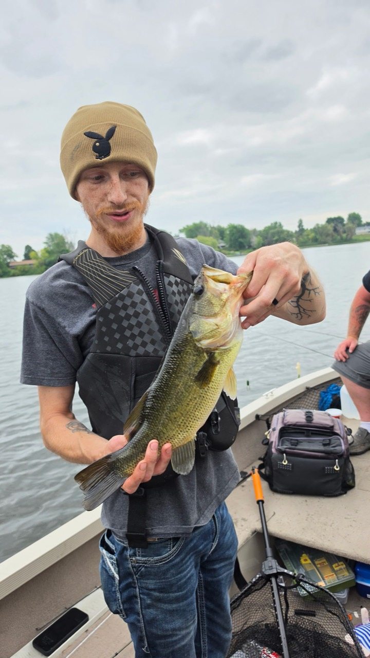 Angler holding a largemouth bass during Slab Foundry field testing